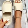 dba31df52967744950af8bdfebf36def773b0d346cbf55addeb77298db6ca336.jpg Women Single Band Slippers, Minimalist Beige EVA Slides For Indoor